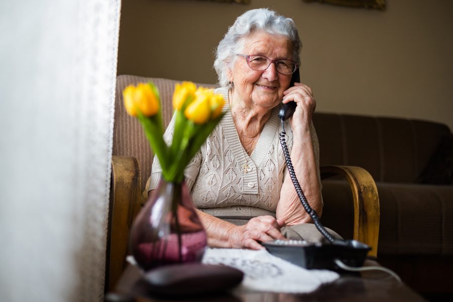 Senior resident speaking on a home phone